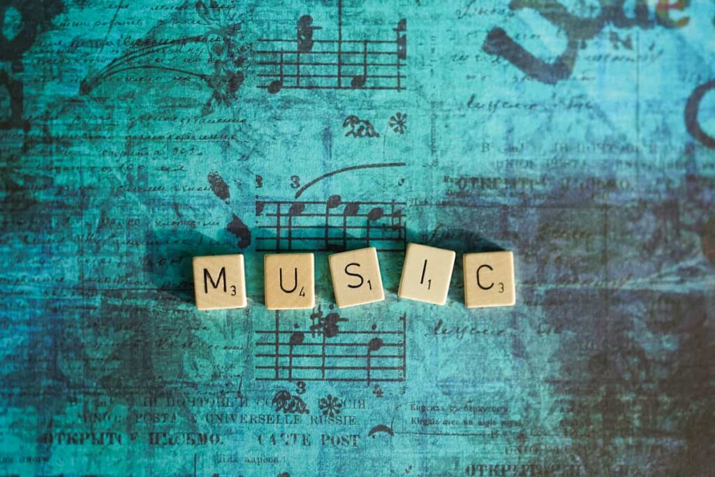 Letras formando la palabra música sobre una partitura antigua