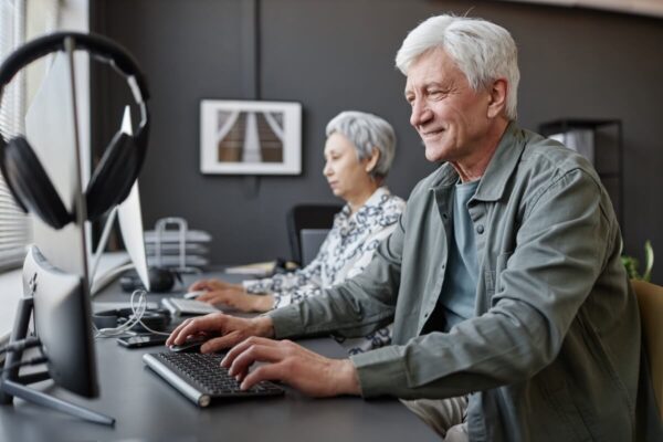 mature-adults-working-at-computers-in-modern-offic-2026-03-24-10-19-54-utc