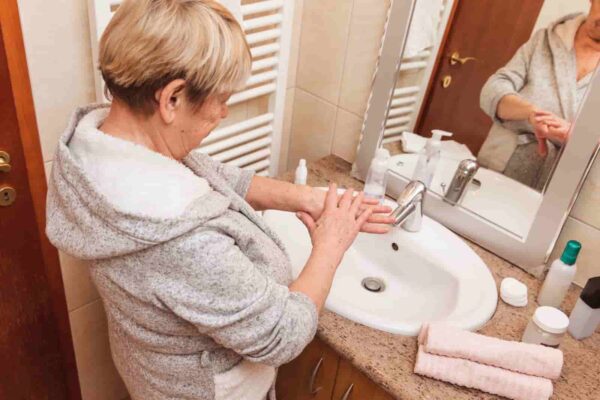 mature-woman-washing-her-hands-in-bathroom-2026-01-09-00-43-27-utc