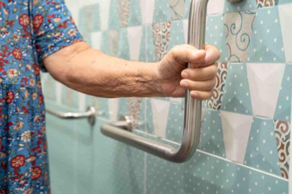senior-adult-hand-gripping-safety-bar-in-bathroom-2026-03-25-03-58-27-utc